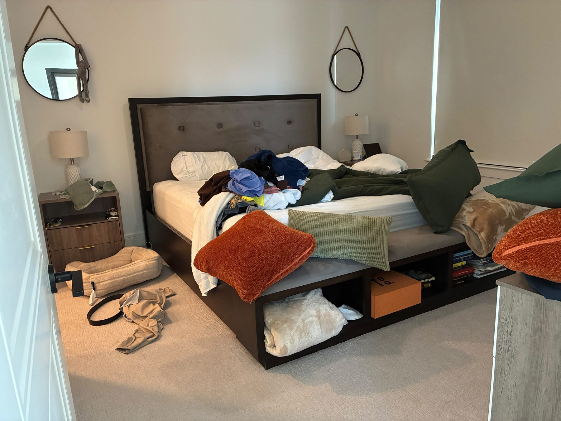 Bedroom before PureGlow cleaning, cluttered with clothes and items
